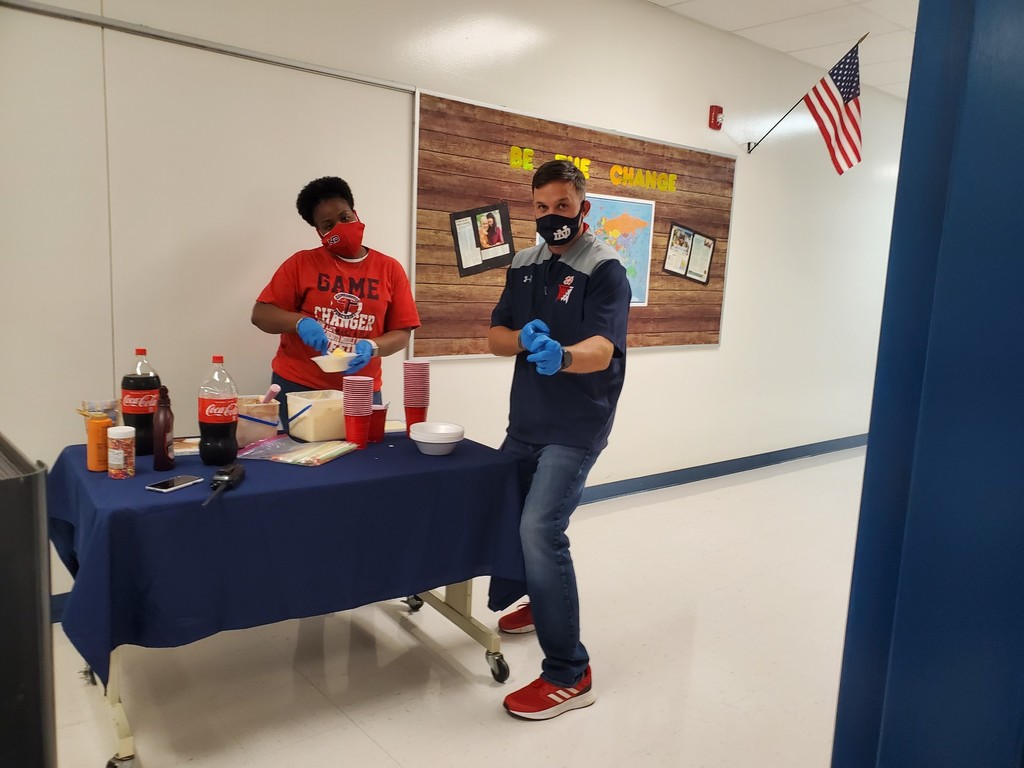 Mr. Carter and Ms. Moses passing out sweet treats to teachers